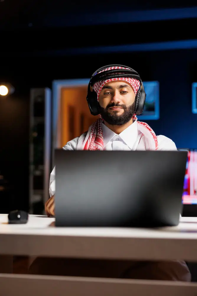 Arab man with headphones and laptop