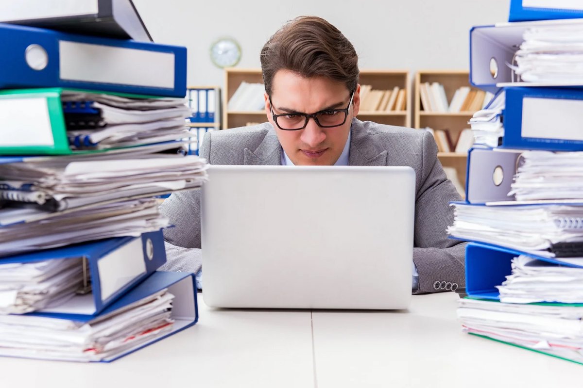 Man using laptop and phone in office