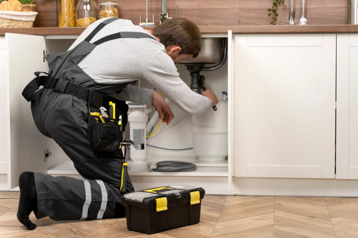Plumber repairing kitchen sink