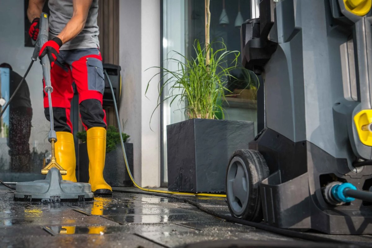 Deep Cleaner worker cleaning surface Using Powerful Pressure Washer