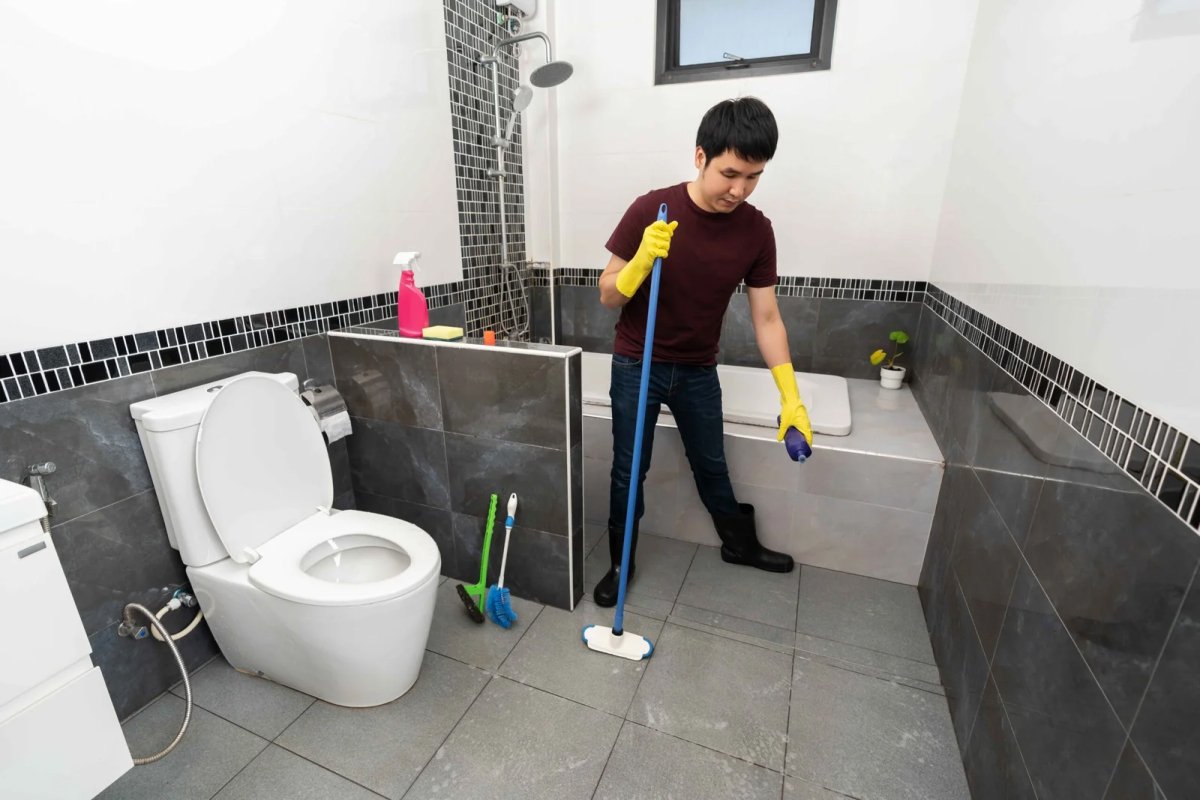 Janitorial cleaning the washroom floor