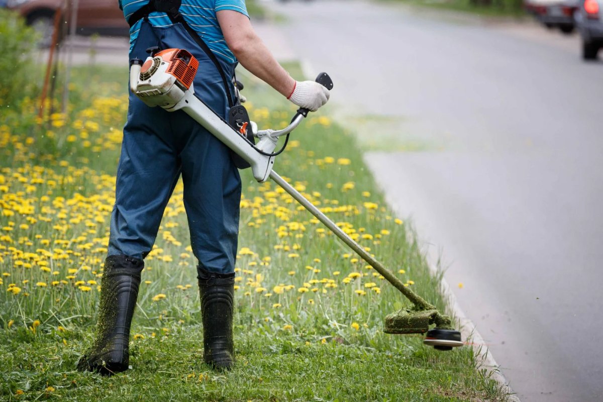 Landscaping Gardner with grass mover