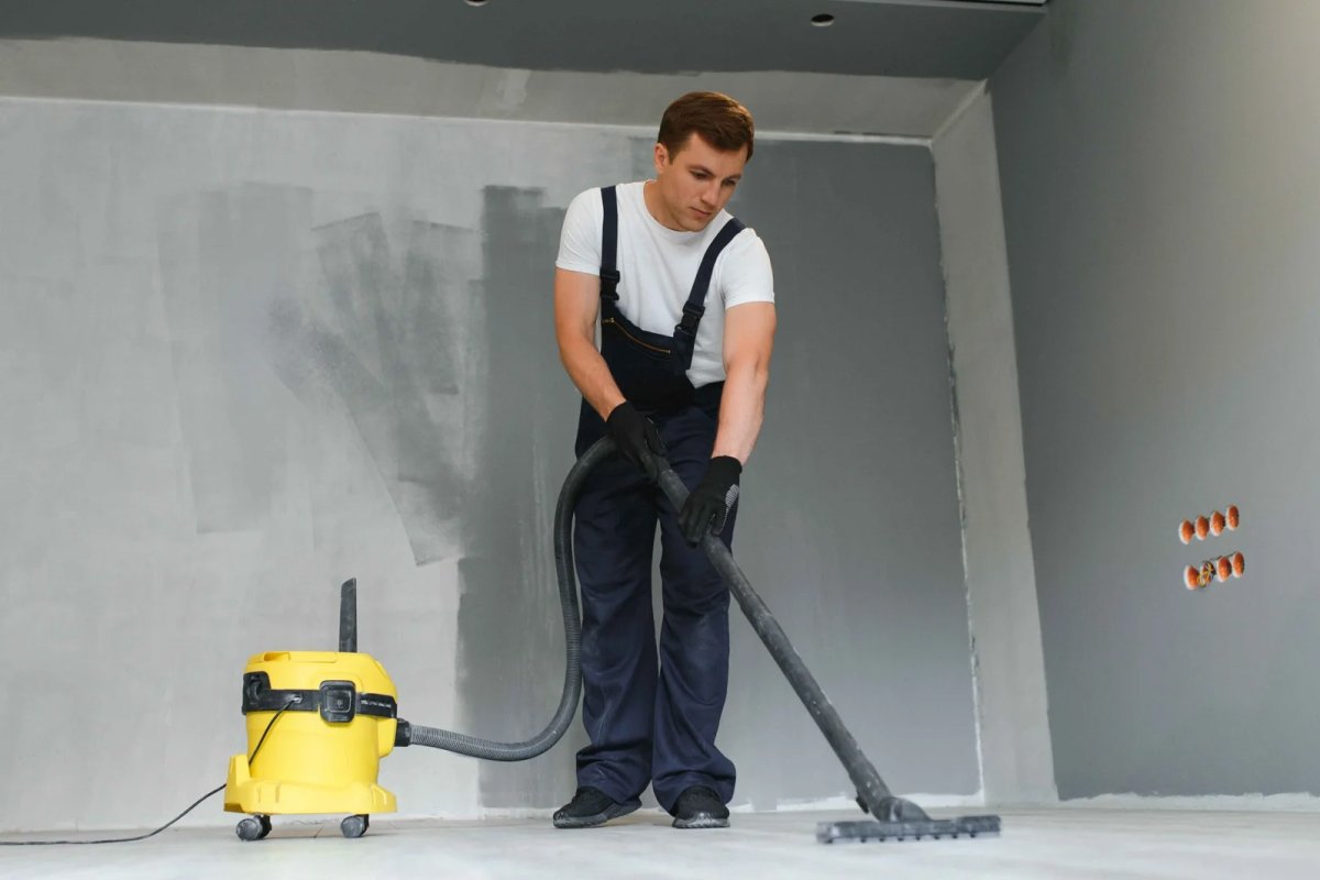 Worker vacuuming a construction site