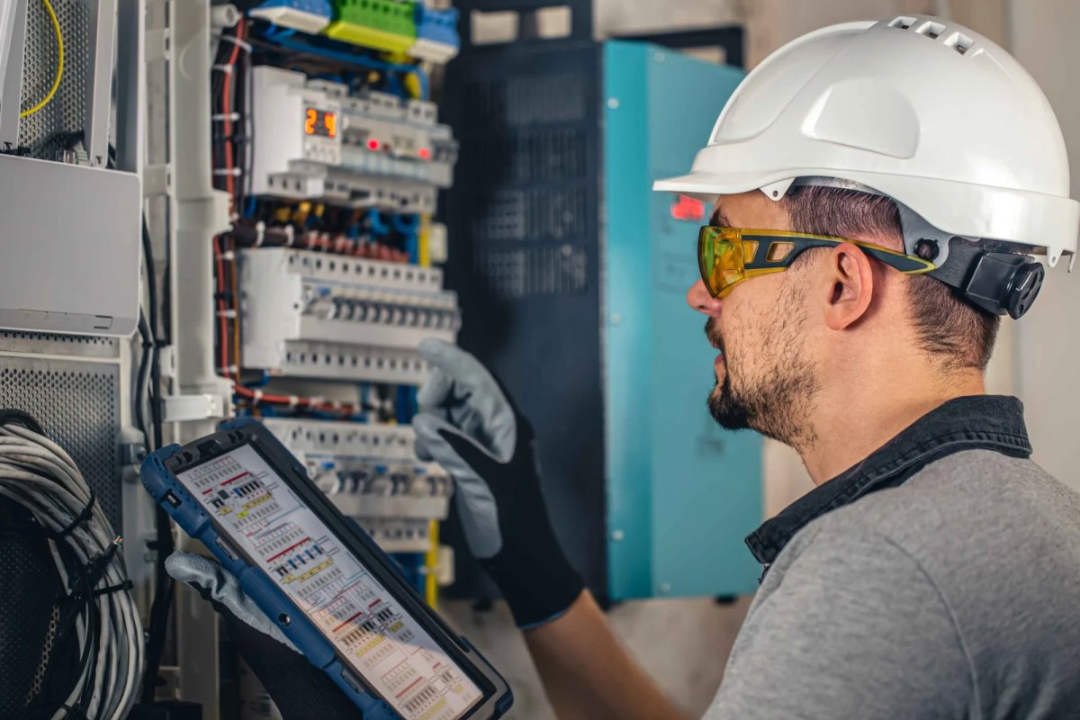 Electrician examining electrical panel