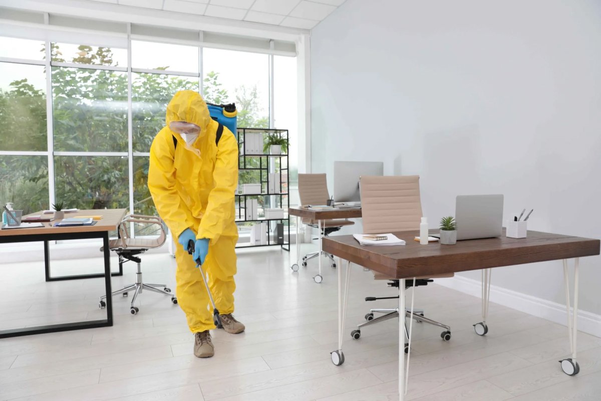 Person in yellow suit spraying
