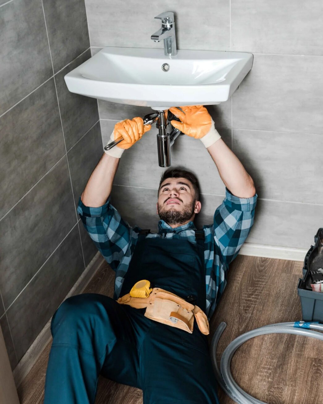 Plumber working on a bathroom sink
