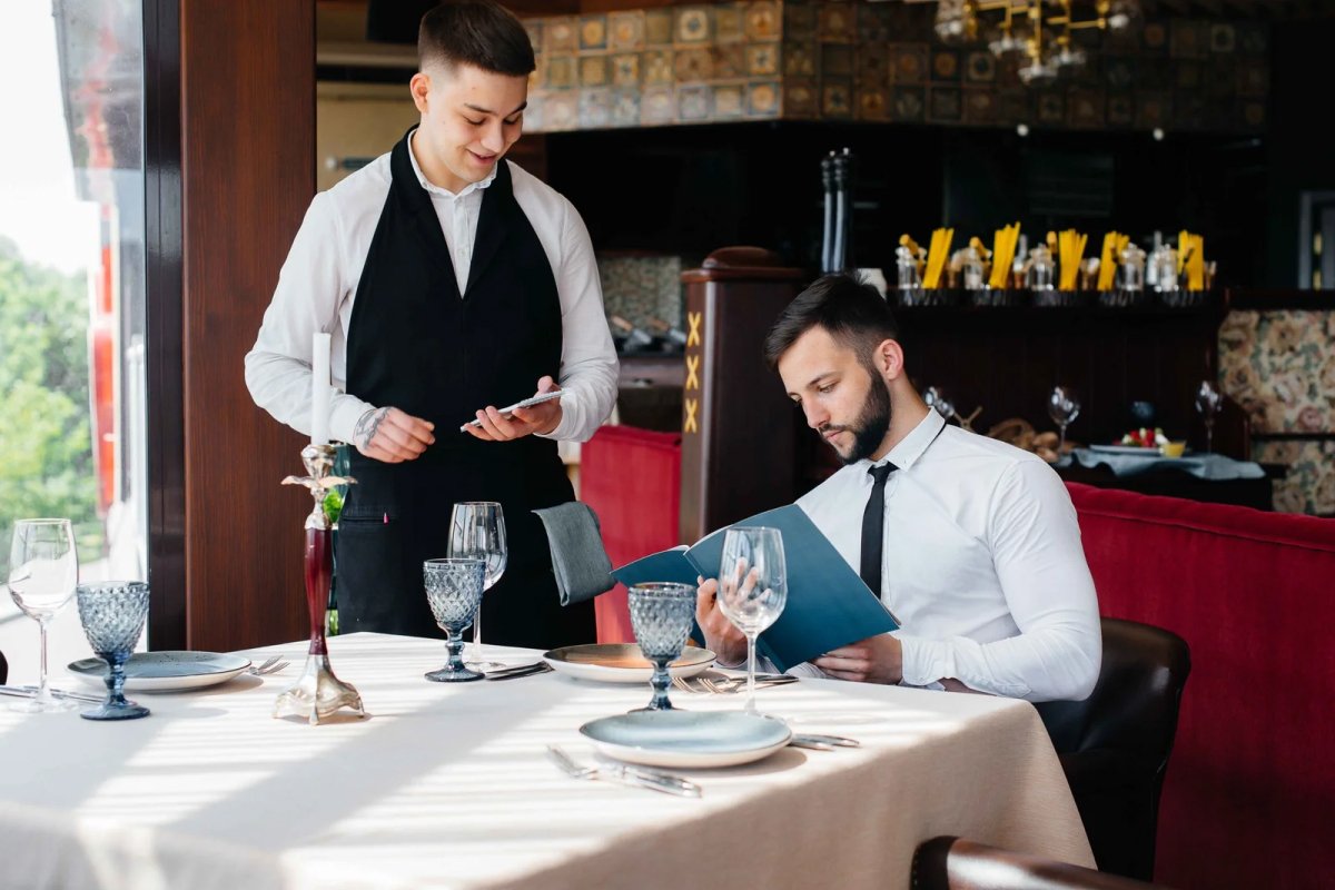 Waiter assisting customer in a restaurant