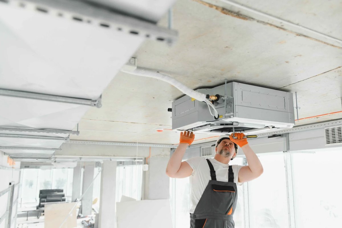 Man installs ceiling air con