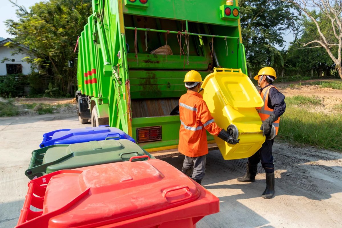 waste disposal workers loading waste on truck